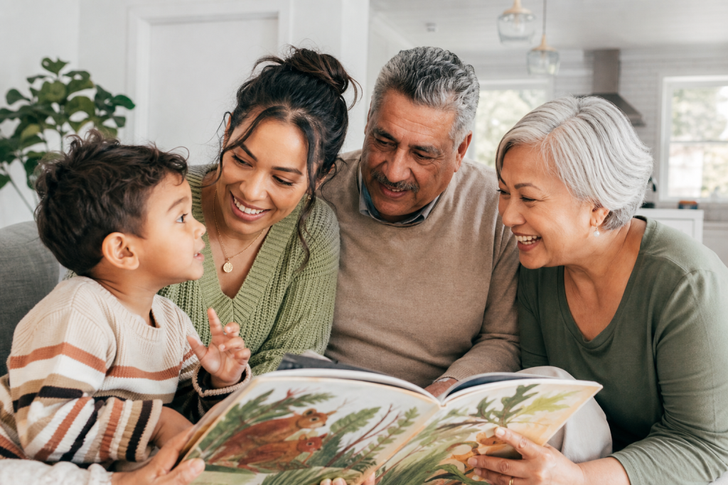 A multilingual family sharing a picture book together in a warm home setting.